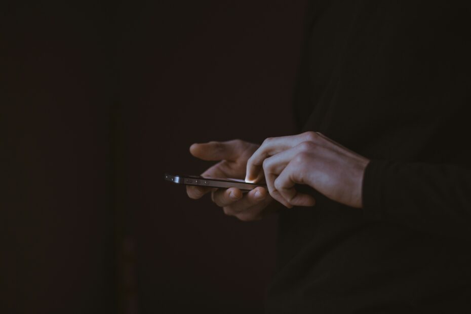 Person holding a smartphone with a mobile app open