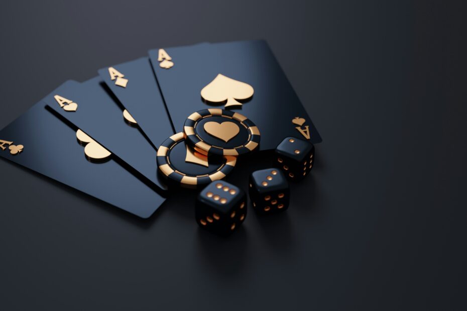Four ace playing cards with poker chips and dice on a dark table