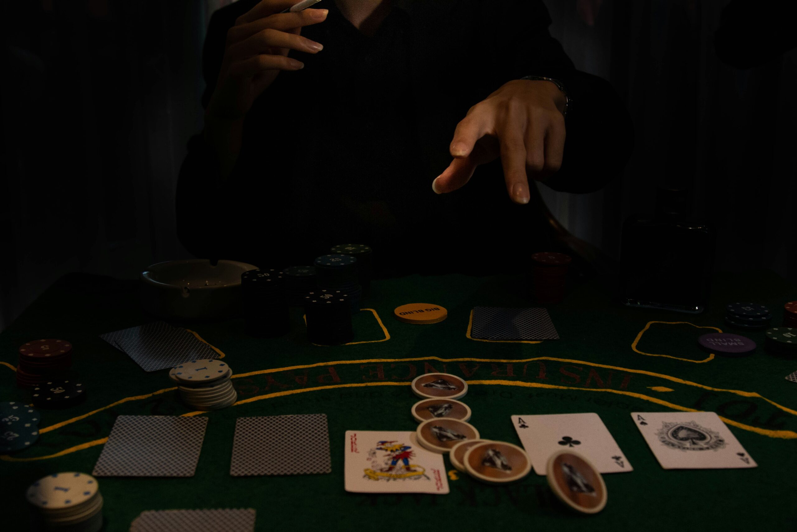 Player sitting at a poker table with cards and chips