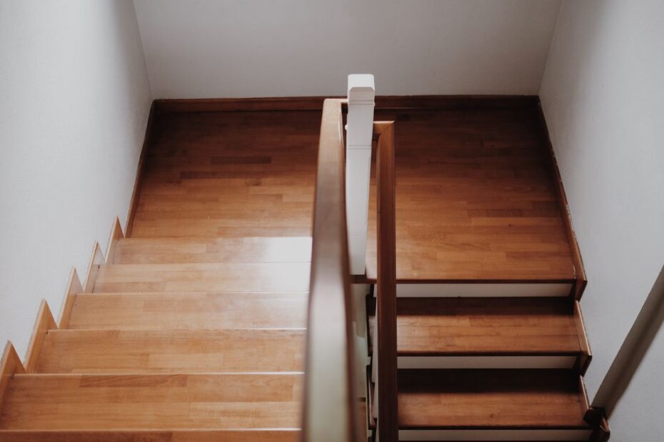 Top-down view of a wooden staircase with a handrail, a picture of blind levels climbing step by step in a poker tournament