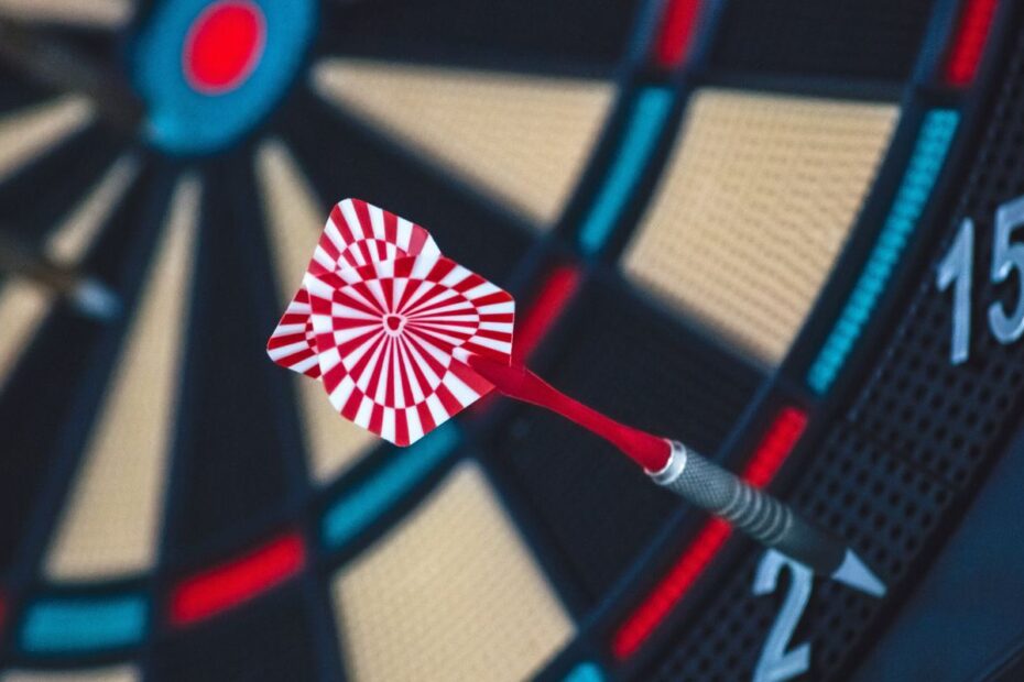 Red and white dart close to the center of a dartboard, a symbol of precision and focus at the poker table